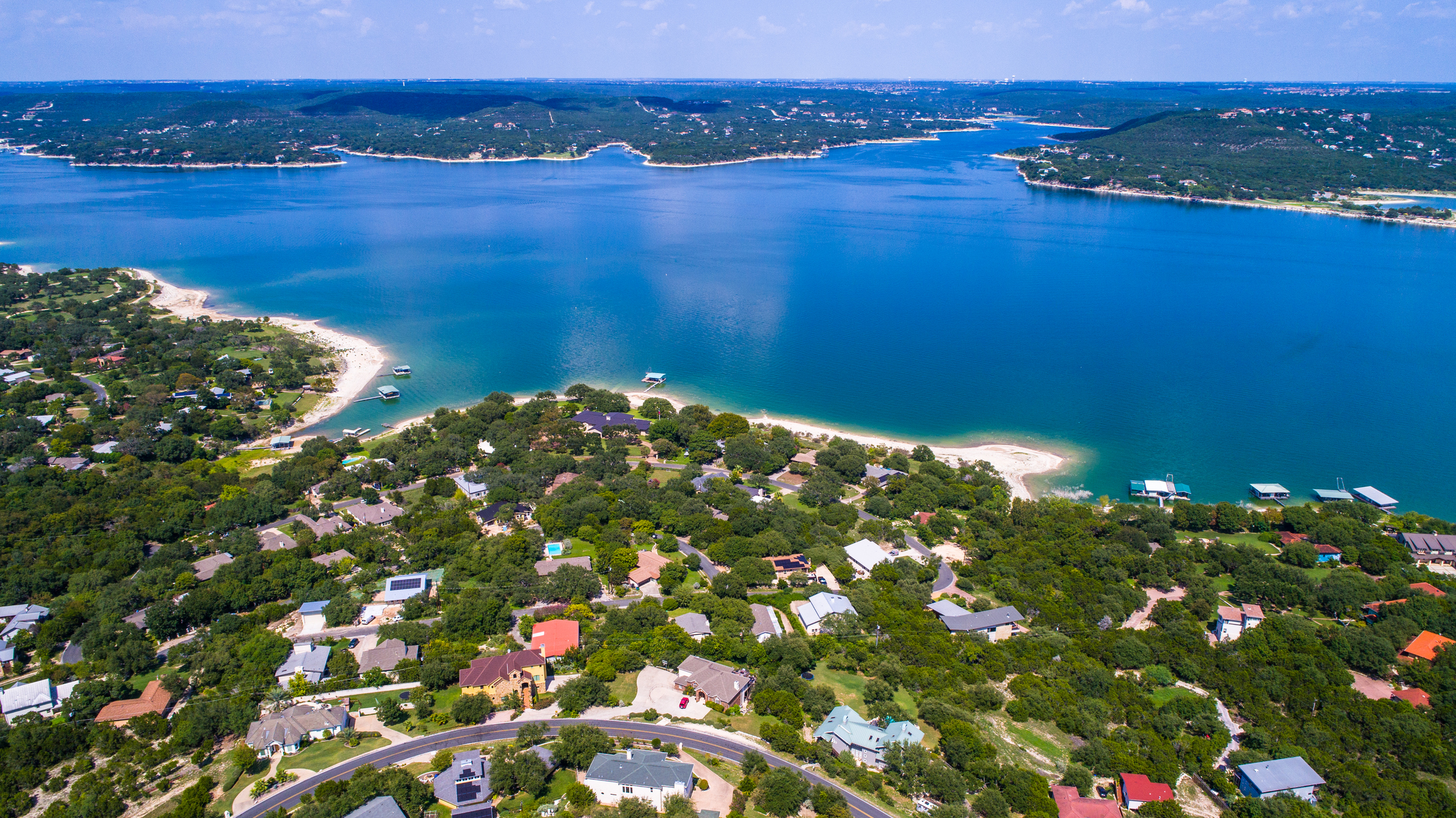 Gorgeous Blue Paradise Lake aerial view above Lake Travis and Lakeway Homes along Water's Edge