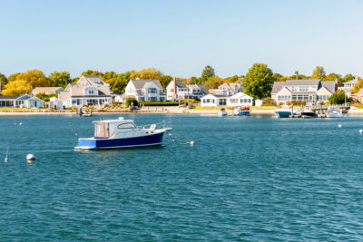 Motorboat moored off a built up coast on a sunny autumn day