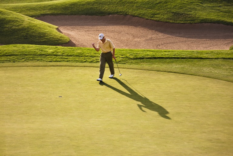 Golfer celebrating making putt