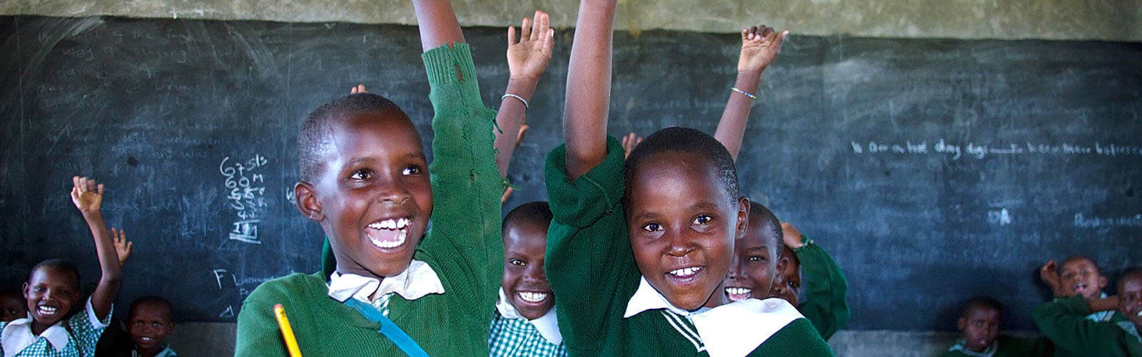 students in Kenya raising hands