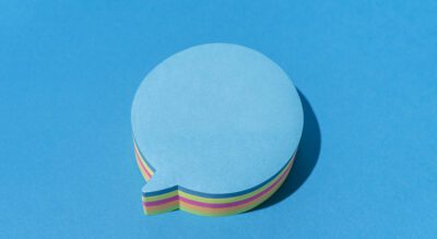 Blue Blank Note In The Shape Of Comic Bubbles On Blue Background