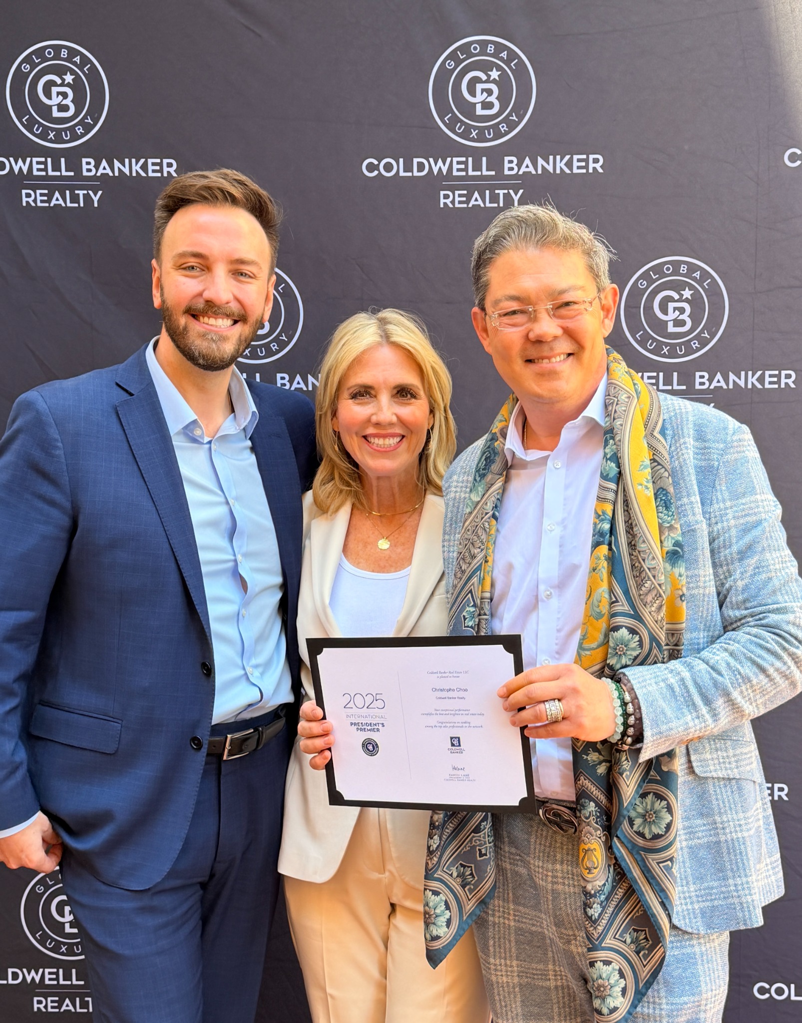 Christophe Choo with Coldwell Banker leadership at Beverly Hills awards event holding top agent certificate
