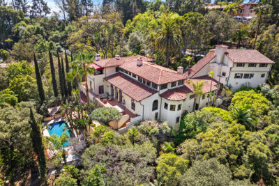 Historic Paul Williams Mediterranean Revival estate in Pasadena sold for $4.5 million by Christophe Choo, Coldwell Banker Realty Beverly Hills the best luxury real estate agent in Los Angeles and Beverly Hills. This aerial view shows the 1.7-acre property with four parcels, private pool, and lush tropical gardens, featuring classic Spanish Colonial architecture by the famed architect Paul Williams.