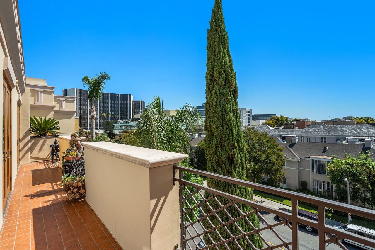 Exterior view of top floor penthouse balconies at 137 S Spalding Dr Beverly Hills