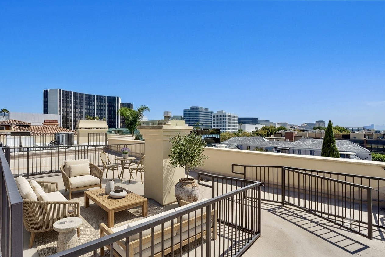Virtually staged outdoor lounge furniture on private deeded rooftop retreat deck at 137 S Spalding Dr #401 Beverly Hills
