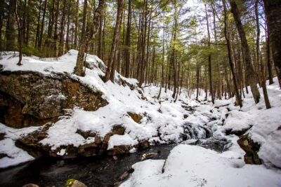 A stream in the snowy woods of the Upper Valley of Vermont and New Hampshire