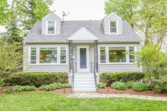 A clean exterior photo of a well-maintained suburban home in DuPage or Cook County with soft natural light.