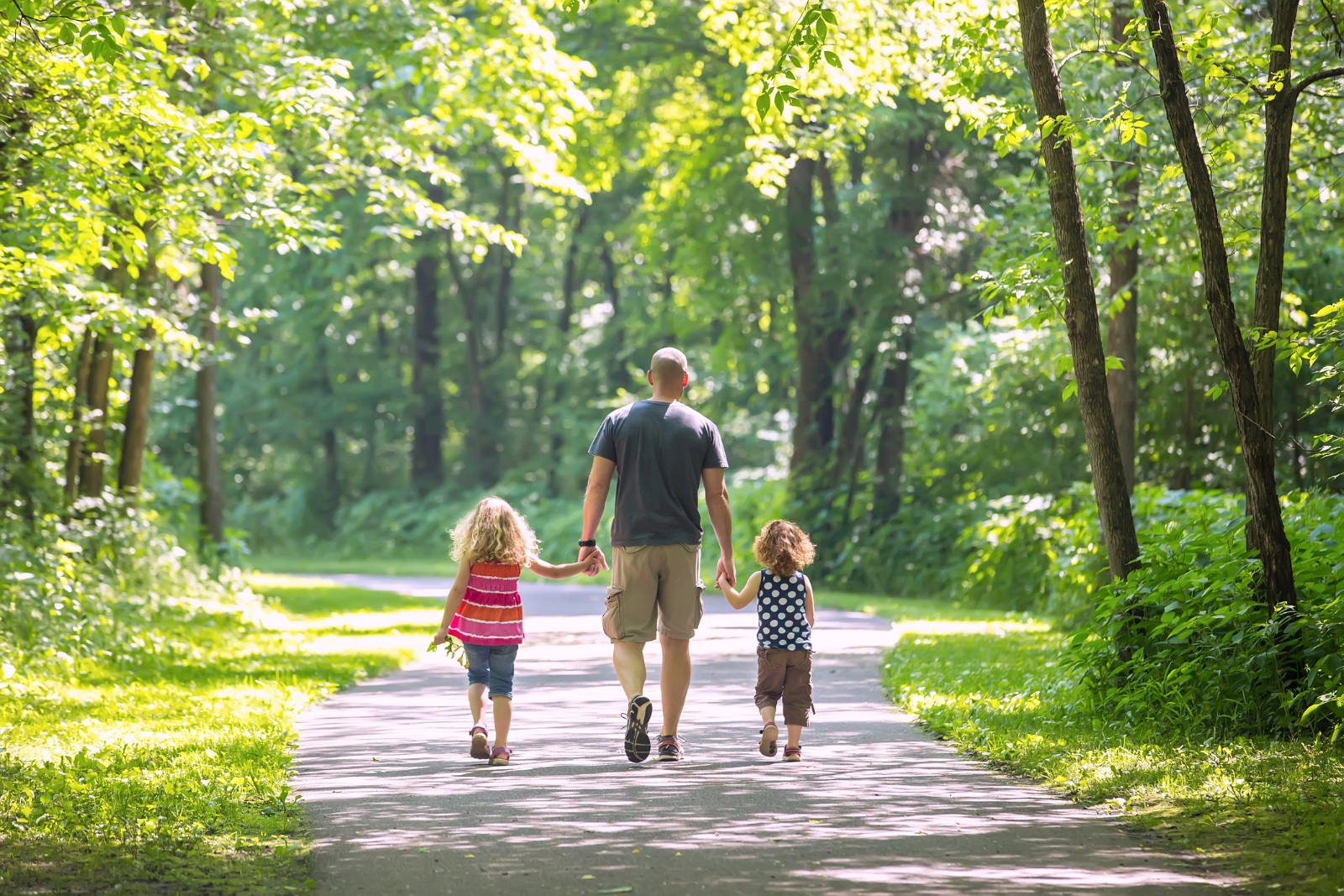 Father And Two Daughters Walking