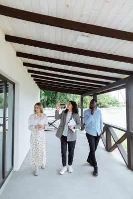 Real estate agent walking through a home with buyers while pointing out features and discussing the importance of a home inspection