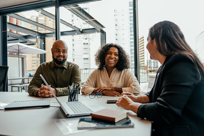 Couple talking to Real Estate Agent