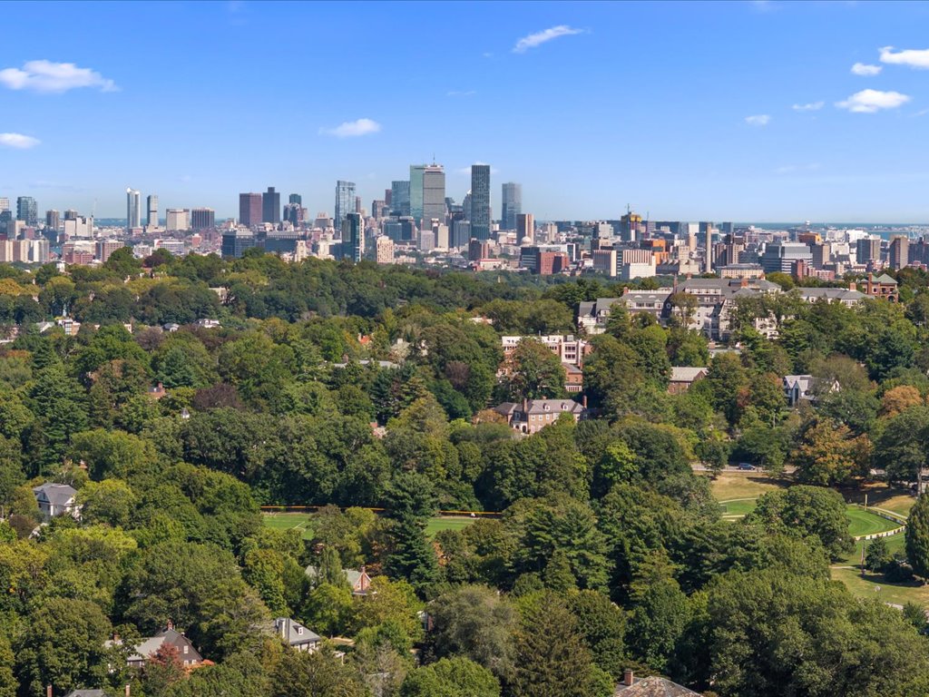 Aerial view of Brookline MA neighborhoods with the Boston skyline in the background