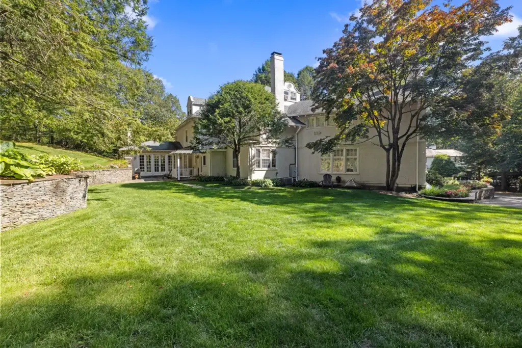 Chestnut Hill luxury home with landscaped lawn and mature trees in Brookline MA
