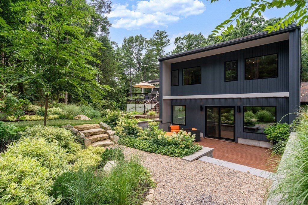 Weston MA luxury real estate: modern custom home with landscaped grounds and stone terracing