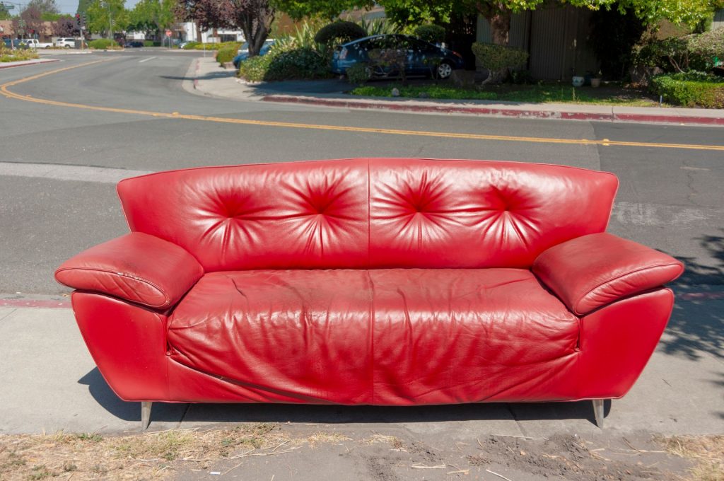 Abandoned red couch on the street