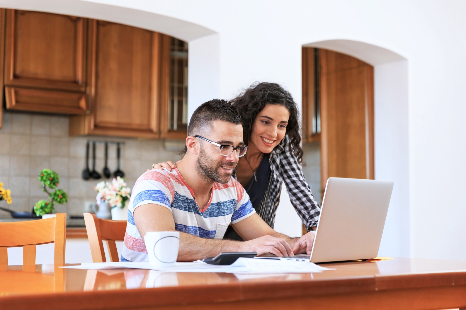 A couple assessing the requirements and questions using a laptop in preparation for their virtual home tour.