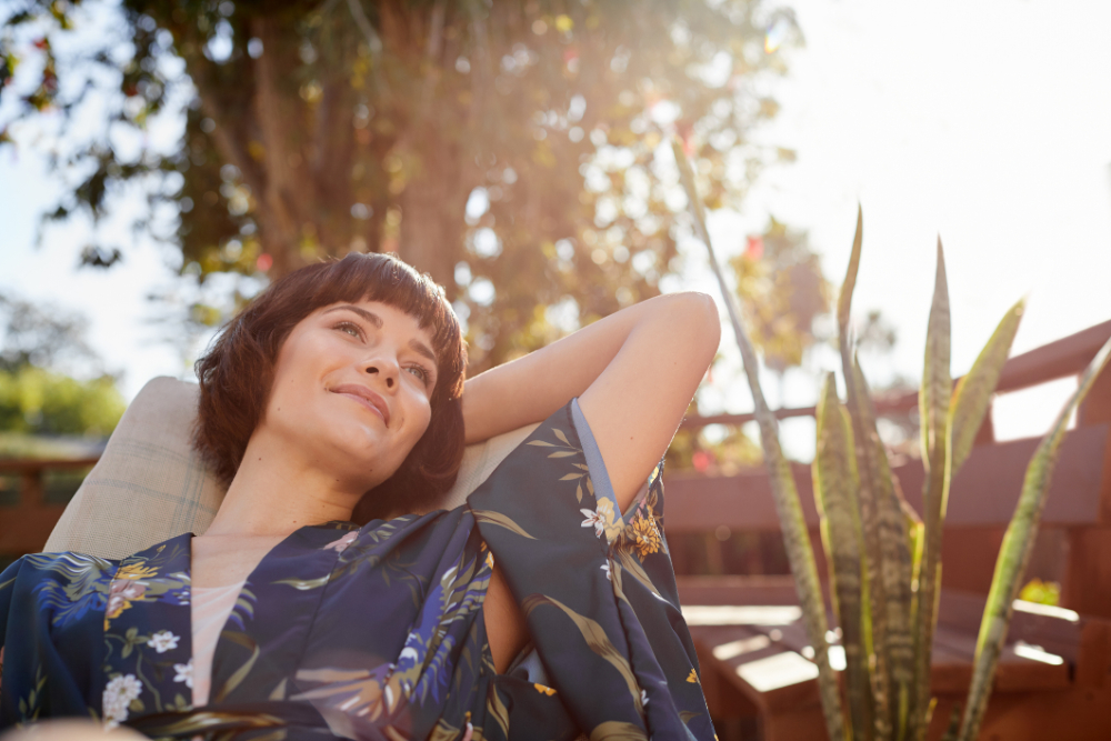 Young woman looking deep in thought and smiling