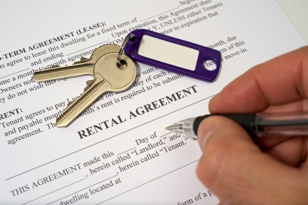 rental agreement document with keys on top