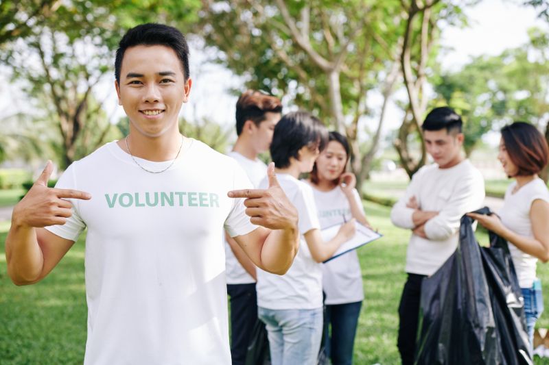man pointing at volunteer inscription