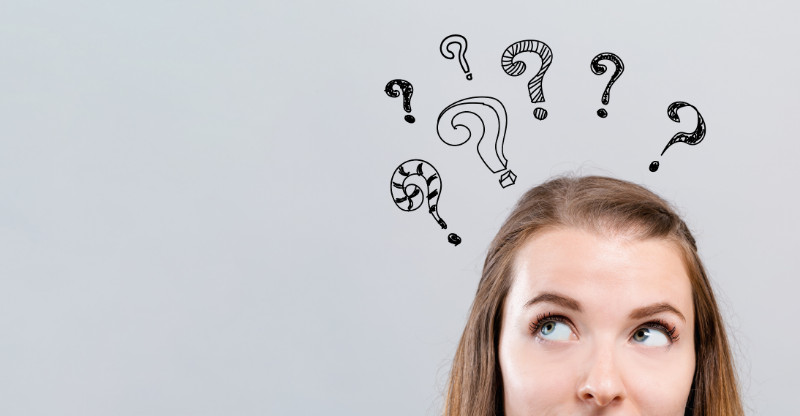 A woman with question marks above her head