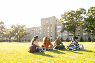 College students sitting on the school field