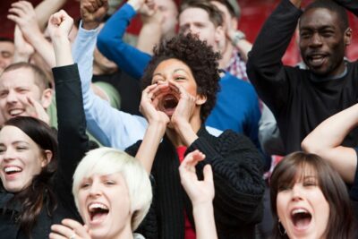 Woman shouting at football match