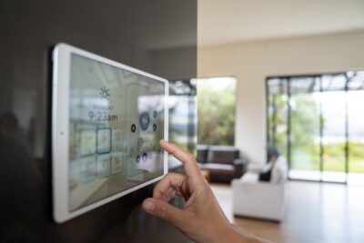 Close-up on a person using a home automation system to control the music