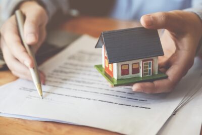 man holding miniature house