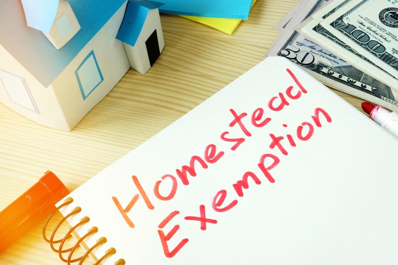 Man writing Homestead Exemption in a note