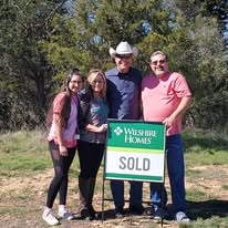James Walker celebrating with clients after they selected the homesite for their new construction home in Central Texas.