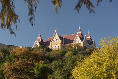 Old Main at Texas State University overlooking the tree-covered hills of San Marcos, Texas