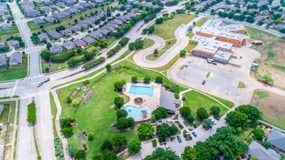 Aerial of Blanco Vista subdivision in San Marcos TX with community pool, park, trails, and elementary school in Hays County Texas
