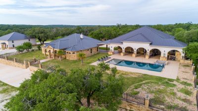 Texas Hill Country estate San Marcos TX aerial view of 761 Allison Lane with luxury home, pool, guest quarters, and acreage views