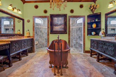 Texas Hill Country estate San Marcos TX primary bathroom with freestanding tub, dual vanities, and walk-through shower