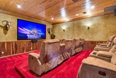 Texas Hill Country estate San Marcos TX private movie theater with recliner seating, large screen, and surround sound setup
