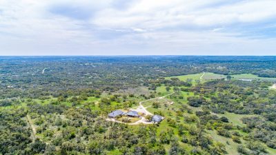 Texas Hill Country estate San Marcos TX aerial view of 761 Allison Lane highlighting luxury home, acreage, and surrounding Hill Country landscape