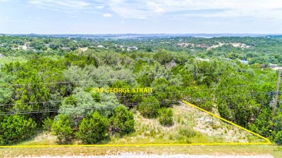 239 George Strait in Fischer TX showing 1.26-acre Canyon Lake TX lot with mature trees and Hill Country terrain