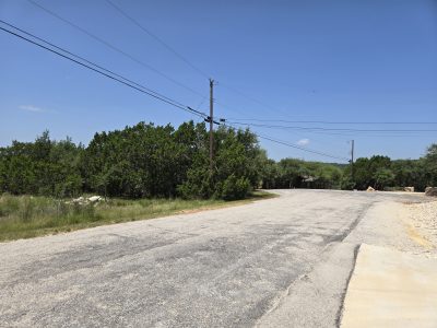 Cul-de-sac street view at 239 George Strait in Fischer TX showing quiet paved road and surrounding Hill Country setting for Canyon Lake TX lot