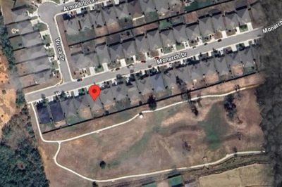 Aerial view showing home backing to greenbelt and walking trail in Arroyo Ranch community