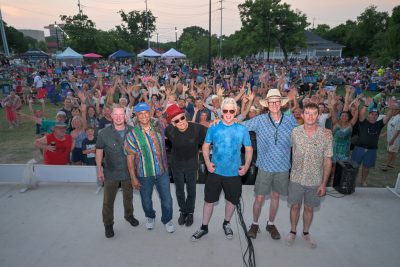 Brave Combo performing at Summer in the Park 2023 in San Marcos Texas with large crowd at Plaza Park