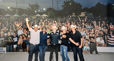 Two Tons of Steel performing at Summer in the Park 2025 in San Marcos Texas with crowd at Plaza Park