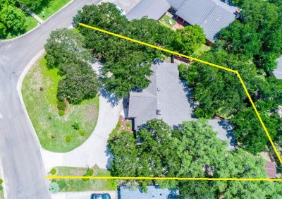 Overhead aerial view of large corner lot with mature tree canopy in established San Marcos neighborhood