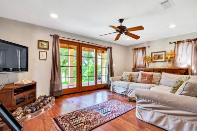 Versatile family room with French doors, hardwood floors, and direct access to the covered patio