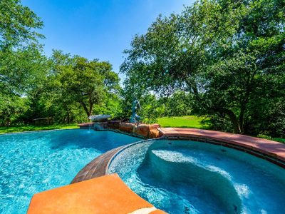 Spa and swimming pool surrounded by mature trees and peaceful outdoor living spaces