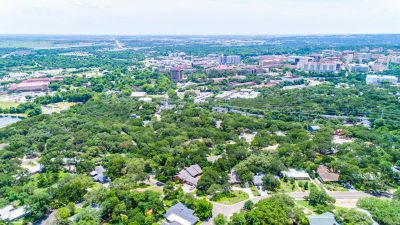 Aerial view of San Marcos Texas featuring established neighborhoods, Texas State University, and the growing downtown area