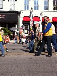 James Walker and his son marching in a veteran's parade in downtown San Marcos, Texas