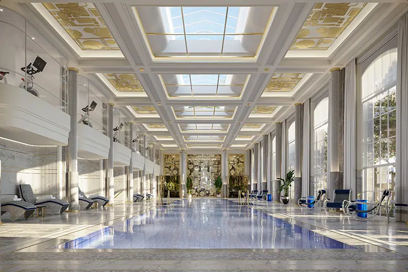 Luxurious indoor pool with marble columns and skylit ceiling at Waldorf Astoria New York Residences