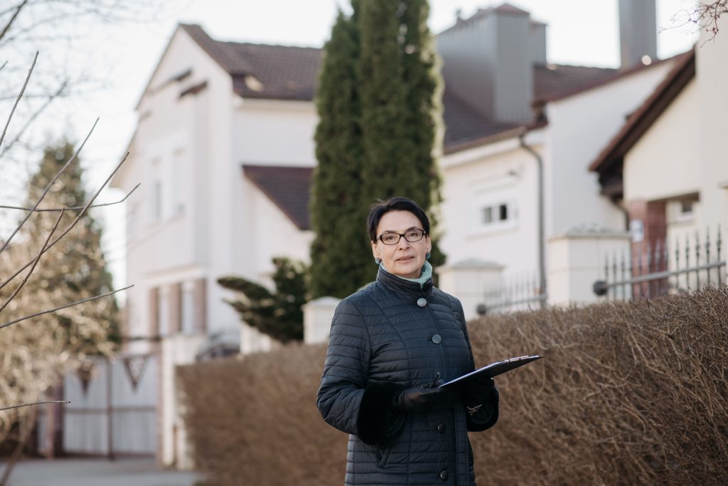 a woman in black jacket holding a clipboard