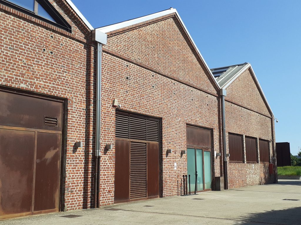 brick industrial warehouses under blue sky