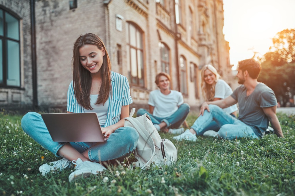 Students sitting on the grass at Harvard University in Cambridge, Massachusetts