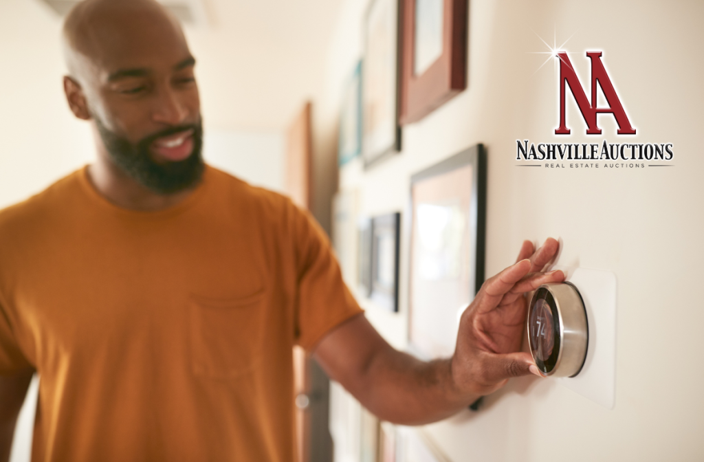 Man turning a thermostat